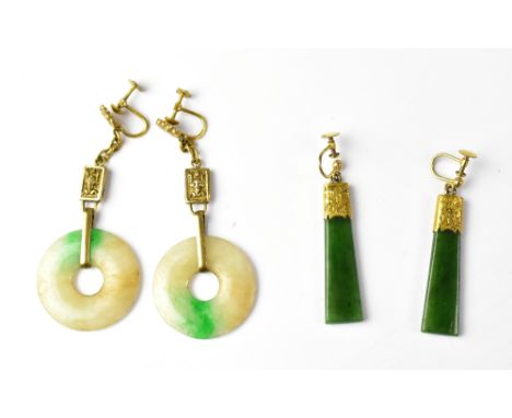 A pair of jade circular drop earrings and a pair of spinach green jade drop earrings with engraved yellow metal embellishment