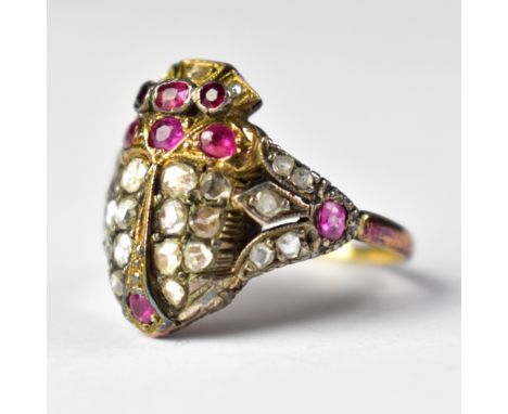An Art Deco Egyptian-style yellow metal ring, the head in the form of a winged scarab, comprising eight rubies and twenty-sev