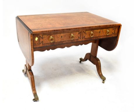 A late 19th/early 20th century walnut sofa table with double ebony inset border to the top, the dome drop flap ends supported