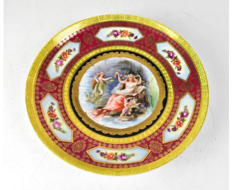 An early 20th century Vienna porcelain wall plate with six floral vignettes to the puce ground border and central panel decor