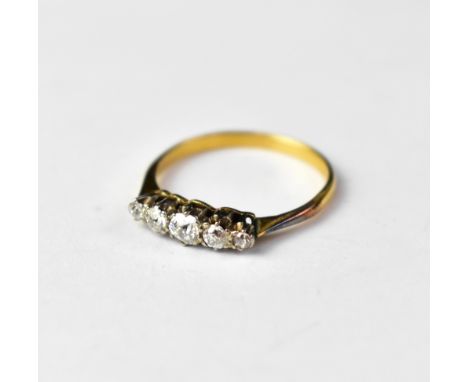 An 18ct gold ring with five claw set graduated brilliant cut diamonds, the principal diamond approx 0.1ct, the smallest 0.03c