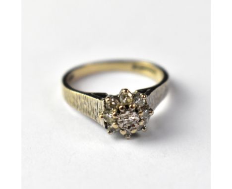 A vintage 18ct white gold diamond cluster ring, the principal illusion set tiny diamond within a halo of eight small claw set