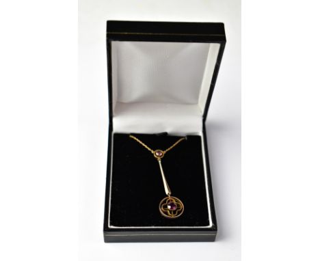 A 9ct rose gold drop pendant with a bezel set amethyst within a quatrefoil and circle, suspended on teardrop, attached to bez