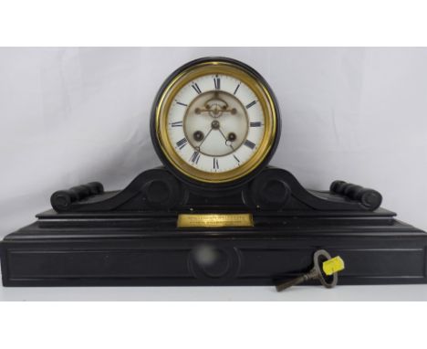 A 19th century black slate clock with barrel movement, the outer white chapter ring set with Roman numerals, with two winding