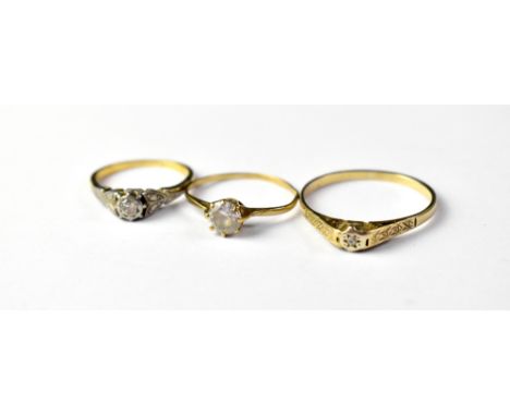 Three gold rings comprising a large 9ct gold example with tiny illusion set diamond, size W, a small illusion set diamond in 