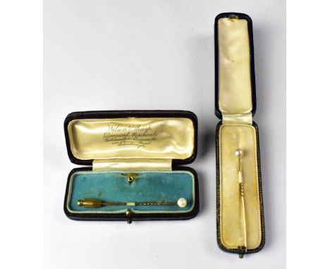 Two yellow metal with cultured pearl top tie pins, length of longest approx 6.5cm, both in presentation cases (2).Provenance: