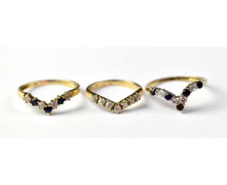 Three 9ct gold wishbone rings, one with five blue stones and four white stones, size O, one with three blue stones and four w