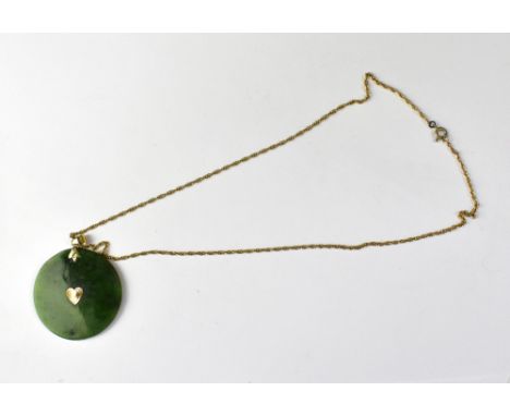 A Chinese circular disc jade-style pendant with 10ct (10K) mounts and necklace hoop, on a gold-coloured dainty chain with lat