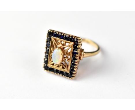 A Victorian-style 9ct rose gold opal ring, the protruding small white oval opal in a claw set mount, within an open square fr