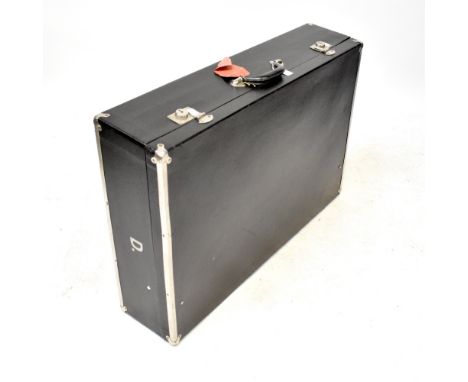 A refurbished vintage black leatherette and metal bound car trunk, with white linen cushioned interior, inscribed to both sid