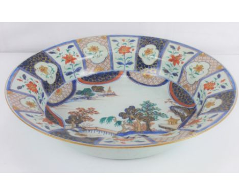 A large late 18th/early 19th century Japanese porcelain bowl, the central panel depicting enamelled gilt decoration of pagoda