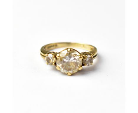 A 9ct gold dress ring set with large clear stone, with smaller white stone either side, indistinct marks, ring size K, approx