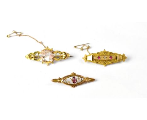 Three 19th century 9ct gold brooches, one of oval centre with tiny diamond chip flanked by two small rubies, one with hearts 
