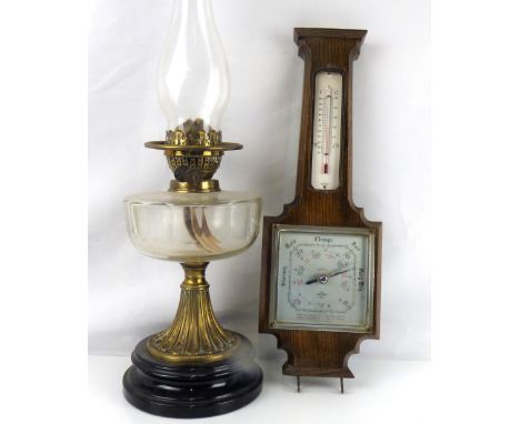 A Shortlands Smith oak cased wall barometer with thermometer and key hooks, length 45cm, together with an oil lamp, the circu
