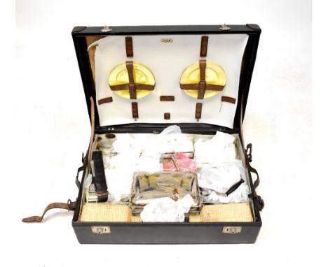 SIRRAM; a vintage black leatherette car trunk picnic hamper fitted with two wicker wrapped square section decanters, white en