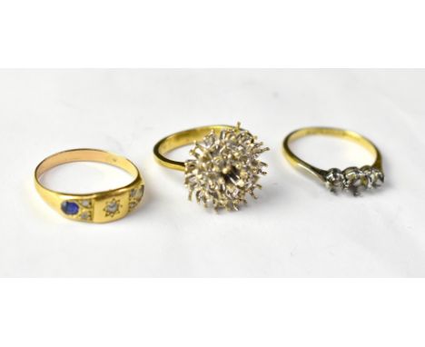 Three 18ct gold rings, each with faults, comprising a cluster ring (lacking all stones), size L, a three-stone ring (lacking 