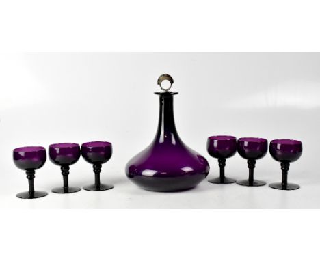 A purple glass mallet-shaped decanter with silver plated stopper, height 25cm, together with a set of six matching purple gla