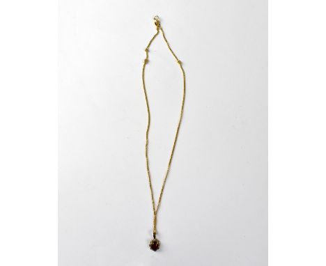An 18ct gold necklace with claw set garnet in a gold pendant mount, length of chain approx 38cm, approx 3.4g. CONDITION REPOR