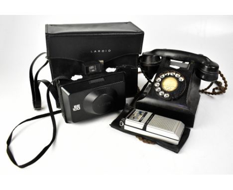 A vintage black pyramid telephone, a cased Polaroid EE100 camera, with paperwork and an Olympus Optical Company Ltd Pearlcord