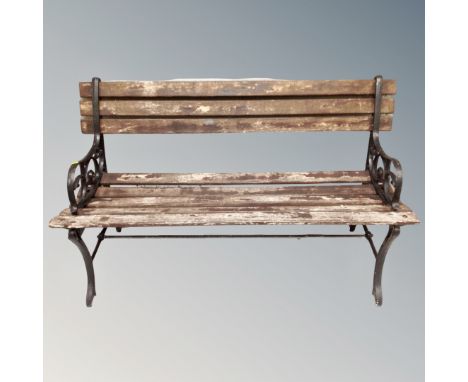 A wooden metal ended garden bench 