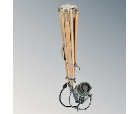 A vintage theatre light, surveyor's wooden tripod 