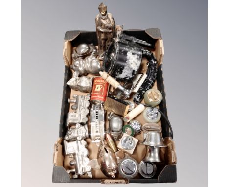 A box of assorted novelty metal money boxes, vintage table lighters, signalling lamp 