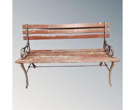 A wooden metal ended garden bench 