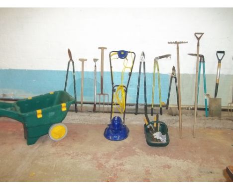 A QUANTITY OF GARDEN TOOLS INCLUDING A MOWER AND A WHEELBARROW