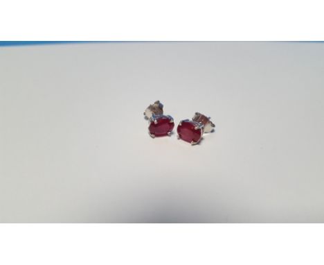 A PAIR OF TREATED RUBY SILVER STUDS