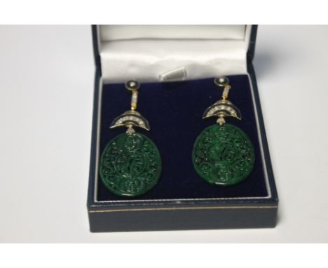 A PAIR OF OVAL SHAPED PATTERNED JADE DROP EARRINGS SET WITH DIAMONDS AND INLAID WITH BLACK ENAMEL, BUTTERFLY BACKS, BOXED