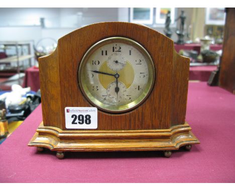 An Early XIX Century Zenith Watch Co Swiss Made Oak Cased Mantel Clock, with two subsidiary dials on brass bun feet.