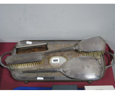 A Hallmarked Silver Backed Three Piece Dressing Table Set, leaf engraved and initialled; a rectangular twin handled plated tr