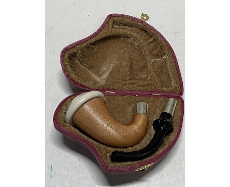 A cased smokers pipe with silver collars 