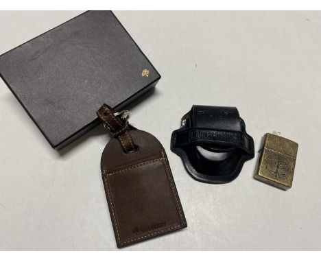 A Zippo lighter and Mulberry luggage tag and also a Harley Davidson pouch 