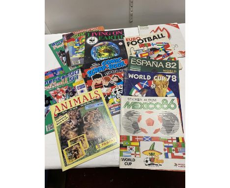 A selection of vintage empty football sticker albums including Panini and other 