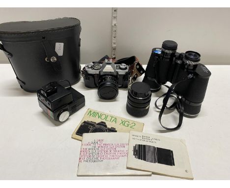 A Minolta XG2 camera and accessories with a pair of cased binoculars (untested), shipping unavailable