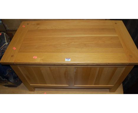 A contemporary light oak hinge topped twin panelled blanket box, w.90cm 