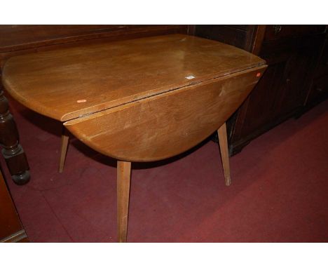 A 1960s Ercol light elm drop flap kitchen table, length 112cmCondition report: Woodworm and losses to base of one leg.  Top w