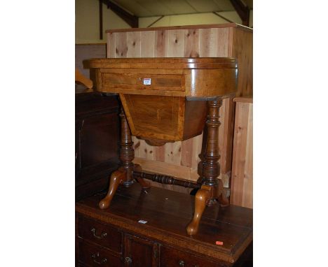 A mid-Victorian and amboyna cross banded fold-over games table, the revolving action enclosing chess board and backgammon ins