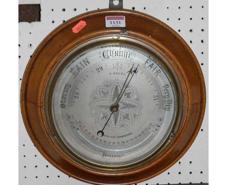 A circa 1900 oak cased circular aneroid barometer, the silvered dial signed R Bailey, 14 Bennetts Hill, Birmingham