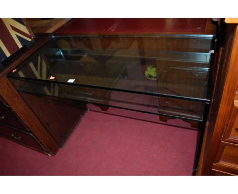 A contemporary heavy glass two-tier console table, width 110cm