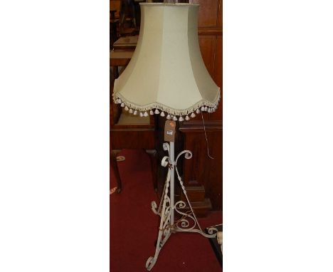 An early 20th century and later white painted wrought iron standard lamp, having telescopic action with shade