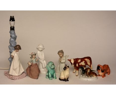 A mixed lot of porcelain figures, to include Nao figural table lamp, Lladro angel figure, Goebel cow, Royal Doulton dog figur