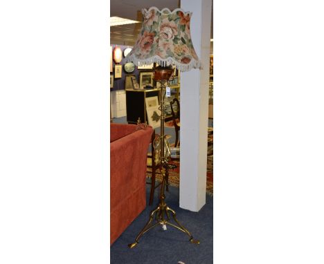 An Arts & Crafts brass and copper oil floor lamp with shade, in the manner of Benson, with stylised decoration, converted to 