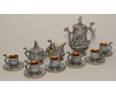 A porcelain six piece coffee set by R Capodimonte Italy, decorated with panels of cherubs, with serpent style handles (16)