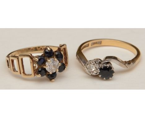 An 18ct gold and platinum sapphire and diamond two stone ring, the round cut sapphire adjacent to a brilliant cut diamond in 