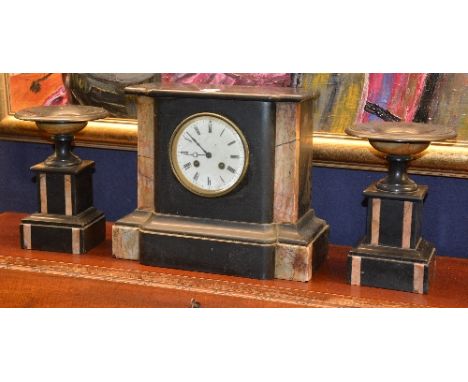 A black slate and marble clock garniture, comprising of mantel clock with a pair of matching side urns, clock 26cm high (3)