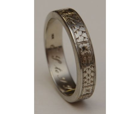 An 18ct white gold gents wedding band, with etched decoration allover, 18k stamped to underside, ring size W, 9.6g