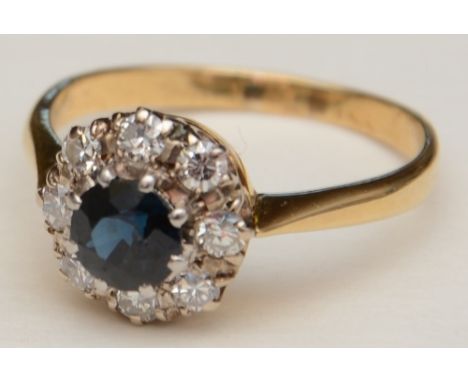 A sapphire and diamond cluster ring, set with central round cut sapphire to centre, surrounded by eight brilliant cut diamond