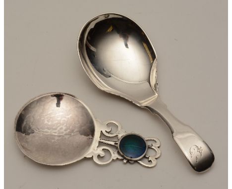 A silver and enamel caddy spoon, hallmarks for Birmingham 2016 by John Shellis, of hammered form with turquoise enamel caboch